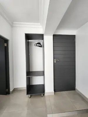 a hallway with two black doors and a pair of shoes at La Chambre Manor House in Nelspruit