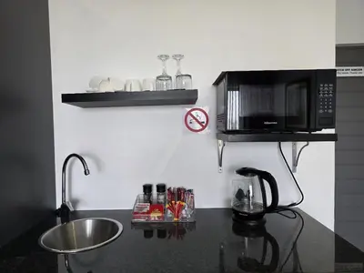 a kitchen with a counter with a microwave and a sink at La Chambre Manor House in Nelspruit