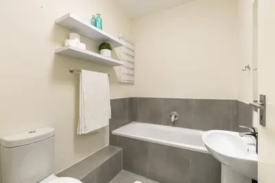 a bathroom with a white toilet and a sink at Modern 2 bed apartment, Secure estate in Midrand