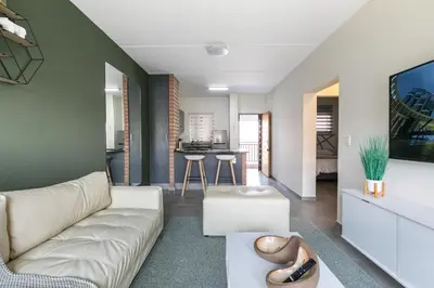 a living room with a couch and a table at Modern 2 bed apartment, Secure estate in Midrand