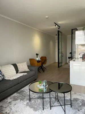 a living room with a couch and a table at Ellipse Executive apartment in Midrand
