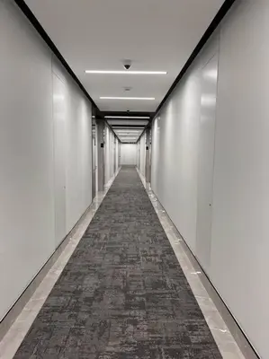 an empty hallway with a long corridor with white walls at Ellipse Executive apartment in Midrand