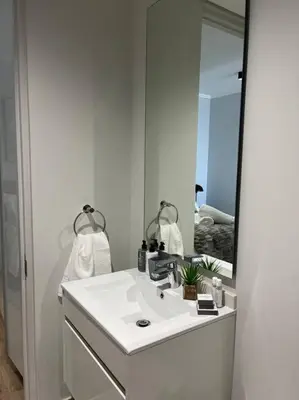 a bathroom with a sink and a large mirror at Ellipse Executive apartment in Midrand