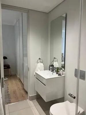 a white bathroom with a sink and a toilet at Ellipse Executive apartment in Midrand