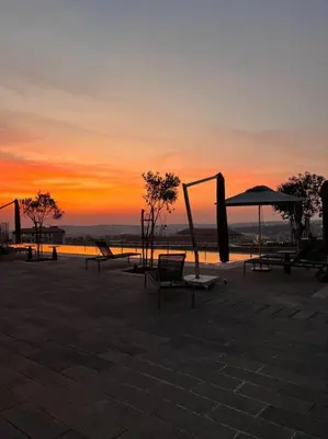 a group of benches and umbrellas at sunset at Ellipse Executive apartment in Midrand