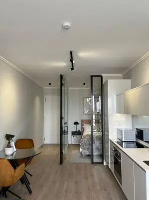 a living room with a kitchen and a bedroom at Ellipse Executive apartment in Midrand