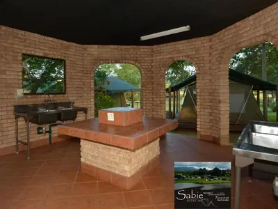 a patio with a sink and a counter in a building at Sabie River Camp in Sabie