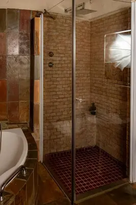 a bathroom with a shower and a bath tub at Harties Lodge - Private Suite in Hartbeespoort