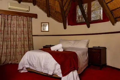 a bedroom with a bed with a towel on it at Manor House at Harties Lodge - Meerhof in Hartbeespoort