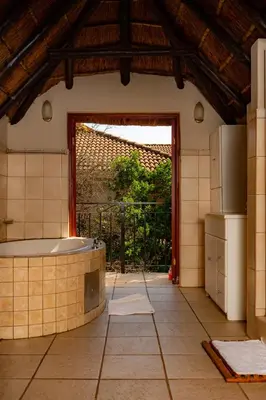 a kitchen with a tub in the middle of a room at Manor House at Harties Lodge - Meerhof in Hartbeespoort