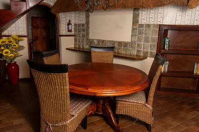 a wooden table and chairs in a kitchen at Manor House at Harties Lodge - Meerhof in Hartbeespoort