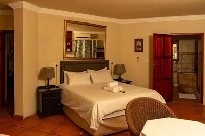 a bedroom with a bed with a teddy bear on it at Harties Lodge - Meerhof Bay View 6 in Hartbeespoort
