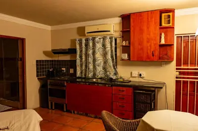 a kitchen with a stove and a counter top at Harties Lodge - Meerhof Bay View 6 in Hartbeespoort