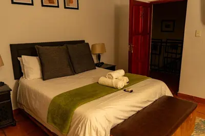 a bedroom with a large bed with towels on it at Harties Lodge - Meerhof Bay View 8 in Hartbeespoort
