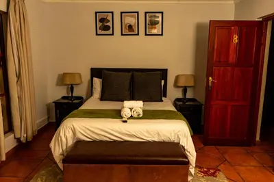a bedroom with a bed with two towels on it at Harties Lodge - Meerhof Bay View 8 in Hartbeespoort