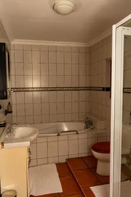 a bathroom with a tub and a toilet at Harties Lodge - Meerhof Bay View 8 in Hartbeespoort