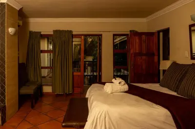 a bedroom with a bed with a stuffed animal on it at Bay View 9 at Harties Lodge - Meerhof in Hartbeespoort