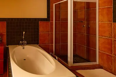 a bath tub in a bathroom with a shower at Bay View 9 at Harties Lodge - Meerhof in Hartbeespoort