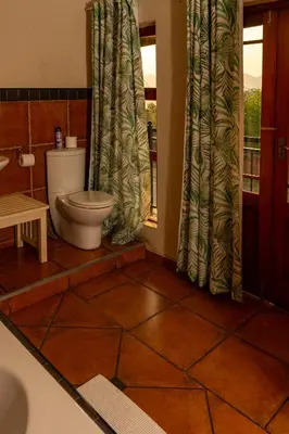 a bathroom with a toilet and a window at Bay View 9 at Harties Lodge - Meerhof in Hartbeespoort