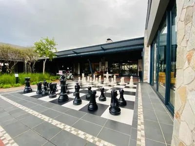 a giant chessboard on a sidewalk in front of a building at 1 Bed in Waterfall - Book 4 & Get 5th Night FREE in Midrand