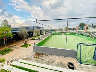 a tennis court with a net on top of it at 1 Bed in Waterfall - Book 4 & Get 5th Night FREE in Midrand