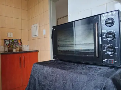 a microwave sitting on top of a table in a kitchen at Modern style Apartment in Pretoria-Central in Pretoria