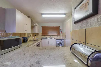 a large kitchen with a sink and a microwave at Kruger Park Lodge Unit No. 524 in Hazyview
