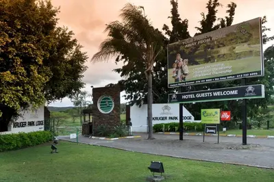 a sign in front of a building with a billboard at Kruger Park Lodge Unit No. 524 in Hazyview