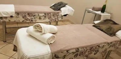 two towels on a bed in a room at Capital Hill Stay at Spa in Pretoria