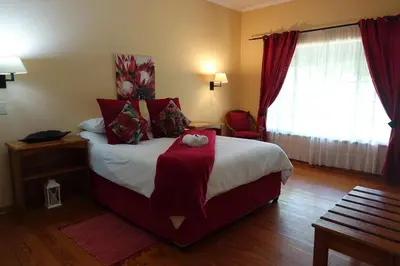 a hotel room with a bed with a teddy bear on it at Ekukhanyeni, The Place of Light in Boschjeskop