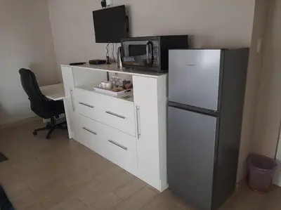 a kitchen with a refrigerator and a microwave at Bonfai Residence in Ermelo