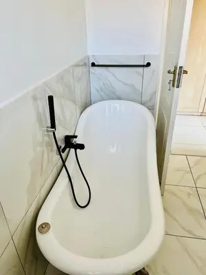 a bathroom with a white toilet in a room at Petalsoft in Pretoria