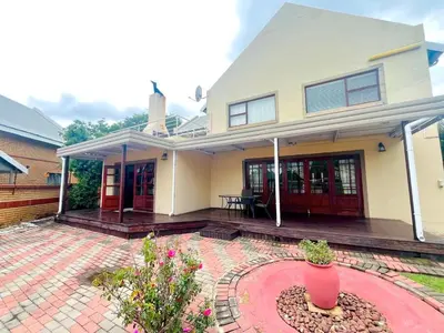 a house with a brick patio in front of it at Petalsoft in Pretoria