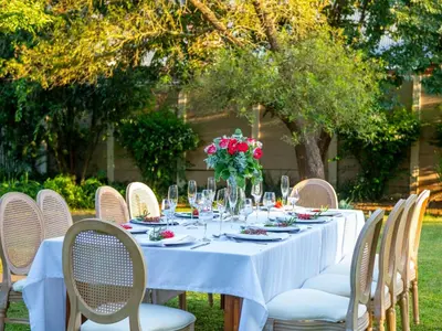 a table with a white table cloth and flowers on it at The Stella Guest House & Spa in Ermelo