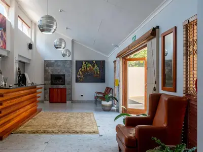 a living room with a couch and a table at The Stella Guest House & Spa in Ermelo