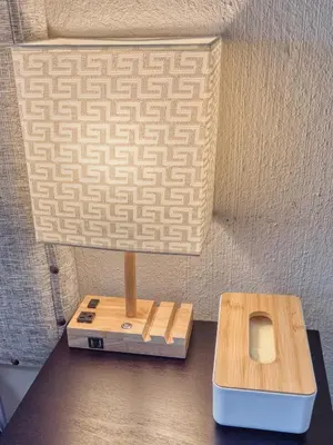 a table with a lamp and a box on it at Tembo Guest Lodge in Hazyview