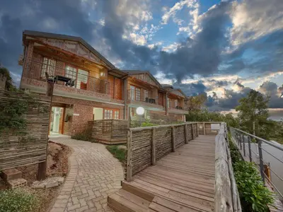 a wooden walkway in front of a building at Tembo Guest Lodge in Hazyview
