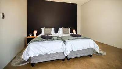 a bedroom with a large bed with two pillows at Highland Gate Golf and Trout Estate 857 in Dullstroom