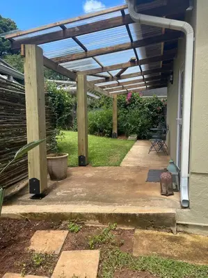 a pergola on the side of a house at Whitehouse cottage in White River