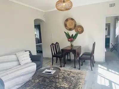 a living room with a couch and a table at Whitehouse cottage in White River