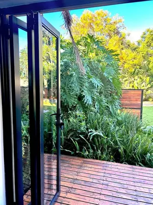 an open sliding glass door on a deck at Apartment close to Menlyn Maine in Pretoria