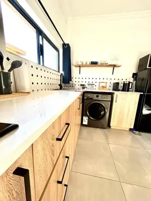 a kitchen with a washer and a washing machine in it at Apartment close to Menlyn Maine in Pretoria