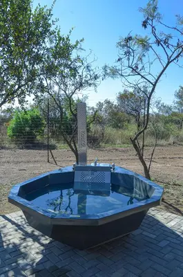 a large tub sitting on top of a brick ground at Letlotse Lodge in Hammanskraal