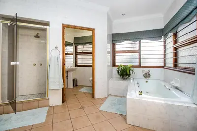 a large bathroom with a tub and a shower at Villa Amor in Pretoria