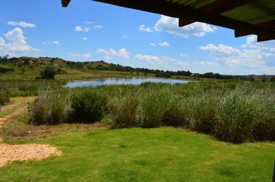 a view of a body of water with tall grass at Woolly Bugger Farm in Tonteldoos