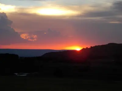 a sunset with the sun setting on the horizon at Woolly Bugger Farm in Tonteldoos