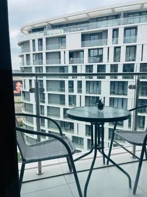 a table and chairs on a balcony with a building at Ellipse Waterfall Luxury Apartment in Midrand