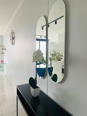 a bathroom with a mirror and a black table with plants at Ellipse Waterfall Luxury Apartment in Midrand