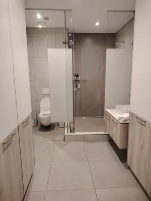 a bathroom with a shower and a toilet and a sink at Menlyn Maine Trilogy Penthouse 42 in Pretoria