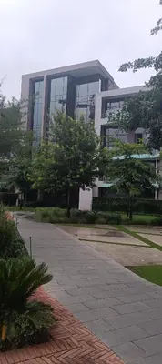 a large building with trees in front of it at Menlyn Maine Trilogy Penthouse 42 in Pretoria